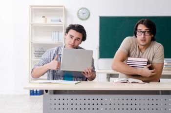 The two male students in the classroom . Two male students in the classroom 