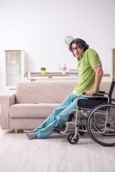 The young male student in wheelchair at home. Young male student in wheelchair at home