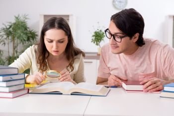 The students preparing for exam together at home . Students preparing for exam together at home 