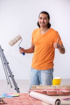 The young man contractor doing renovation at home . Young man contractor doing renovation at home 