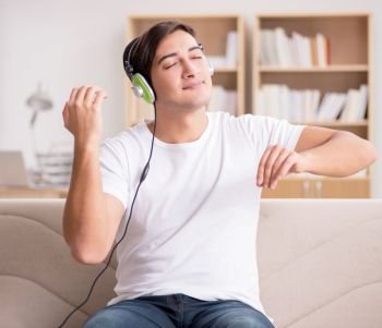 The man listening to music at home. Man listening to music at home