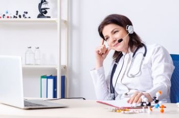 The middle-aged female doctor in telemedicine concept . Middle-aged female doctor in telemedicine concept 