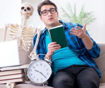 The student studying with skeleton preparing for exams. Student studying with skeleton preparing for exams