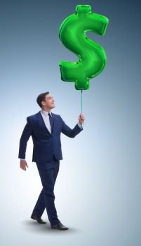 Businessman walking with inflatable dollar sign. The businessman walking with inflatable dollar sign