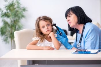 The little girl visiting old female doctor. Little girl visiting old female doctor