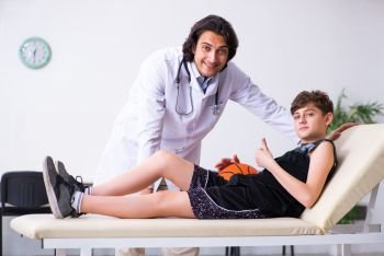 The boy basketball player visiting young doctor traumatologist. Boy basketball player visiting young doctor traumatologist