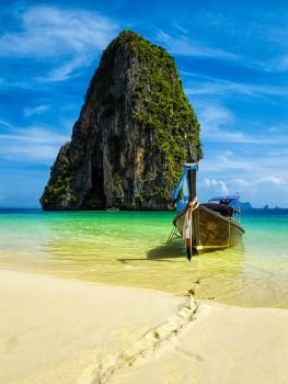 Long tail boat on tropical beach with limestone rock, Krabi, Thailand. Long tail boat on beach, Thailand