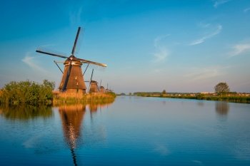 Netherlands rural lanscape with windmills at famous tourist site Kinderdijk in Holland on sunset with dramatic sky. Windmills at Kinderdijk in Holland. Netherlands