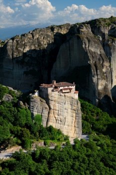 Monastery of Rousanou perched on a cliff in famous greek tourist destination Meteora in Greece on sunset with scenic landscape. Monastery of Rousanou in Meteora in Greece