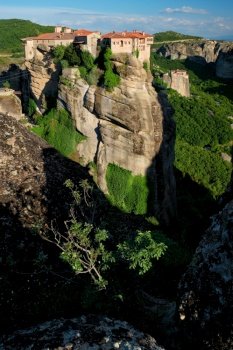 Monastery of Varlaam and Monastery of Rousanou in famous greek tourist destination Meteora in Greece on sunset with scenic scenery landscape. Monasteries of Meteora, Greece