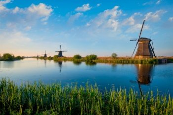 Netherlands rural lanscape with windmills at famous tourist site Kinderdijk in Holland on sunset with dramatic sky. Windmills at Kinderdijk in Holland. Netherlands