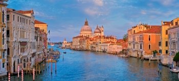 Panorama of Venice Grand Canal with boats and Santa Maria della Salute church on sunset from Ponte dell’Accademia bridge. Venice, Italy. Panorama of Venice Grand Canal and Santa Maria della Salute church on sunset