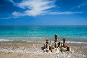 Concept of balance and harmony. Stones pebbles stacks on the beach coast of the blue sea in the nature. Meditative art of stone stacking.. Concept of balance and harmony - pebble stone stacks on the beach