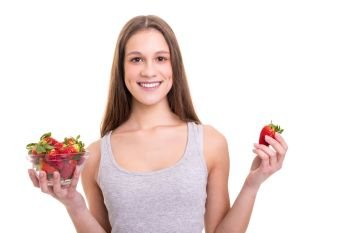 Beautiful young woman holding some strawberries, isolated over white background