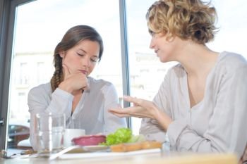 portrait of women chatting over lunch