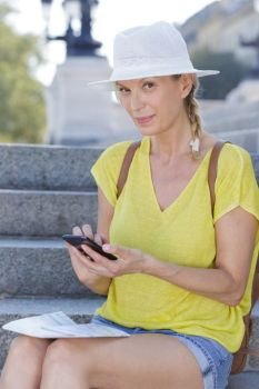 trendy attractive woman checking her phone