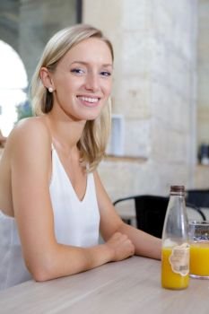 woman with orange juice and food at the bar kitchen