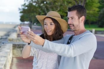 portrait of cheerful couple taking selfie picture