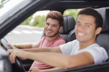 man and friend driving car
