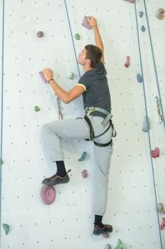 a young man wall climbing