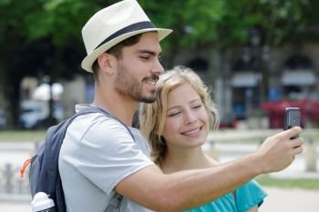 young couple taking simple selfie on the road