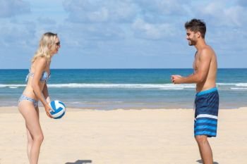 a couple playing beach volleyball