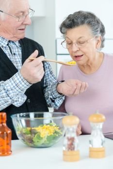 senior couple cooking healthy vegetarian meal