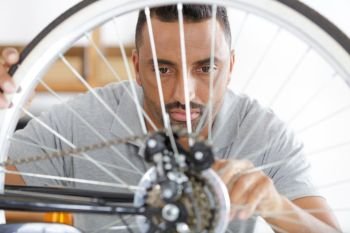 man fixing a bike wheel