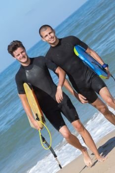 two handsome guys ready for surfing