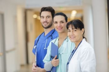 team of doctors standing in the hospital corridor