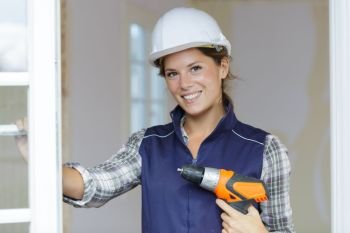 happy woman power tools for work at home