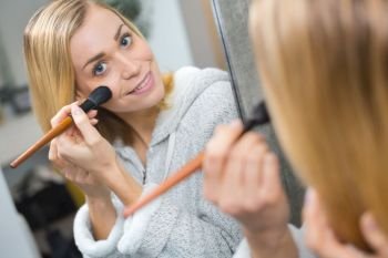 woman doing morning makeup routine