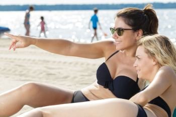 two young woman enjoying the beach