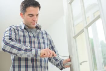 Handyman fitting a new door