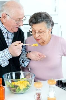 senior couple preparing fresh salad together