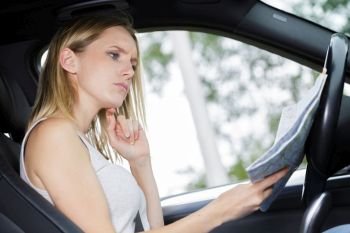female driver looking at map
