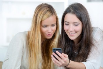 two female friends reading a text message