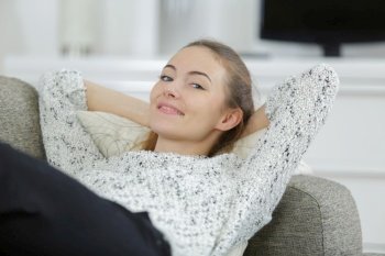 happy young female on sofa