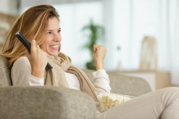 happy woman watching football game on tv