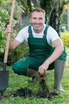 portrait of happy senior man gardening outdoors