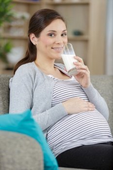 happy pregnant woman drinking milk