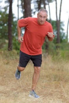 middle aged man jogging in park