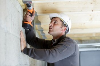 handyman mature home improvement drilling wood
