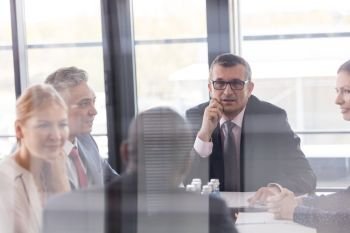 Multi-ethnic business people having discussion in board room at office