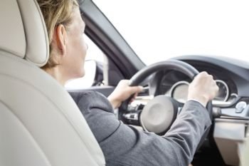 Mature executive driving car during business trip