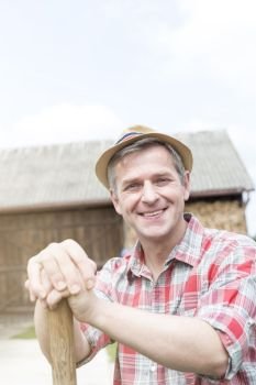Portrait of smiling farmer wearing hat at farm