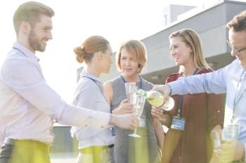 Mature businessman toasting wineglass during success party on rooftop