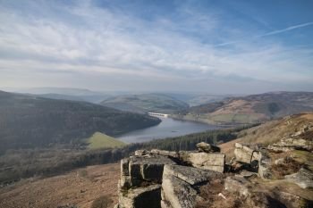 Beautiful landscape image of the Peak District in England viewed from Bamford Edge with Ladybower Reservoir under a beautiful blue Winter sky