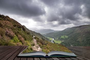 Beautiful landscape image of view from Precipice Walk in Snowdonia overlooking Barmouth and Coed-y-Brenin forest coming out of pages in magical story book