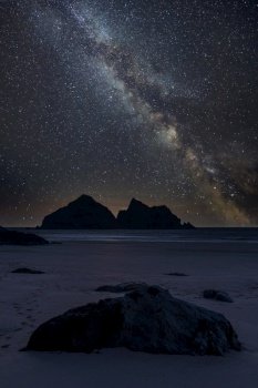 Digital composite image of Milky Way and Epic Absolutely stunning landscape images of Holywell Bay beach in Cornwall UK 